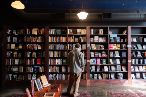 A customer looking at books at Maze Books in Rockford, IL. 